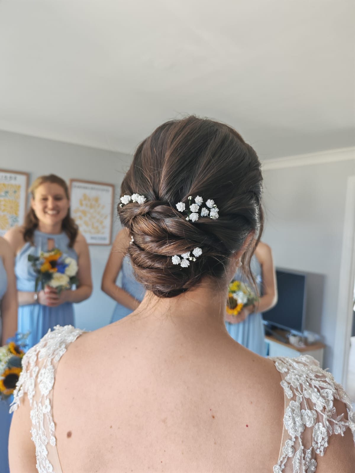 Bridal low bun decorated with delicate white flowers