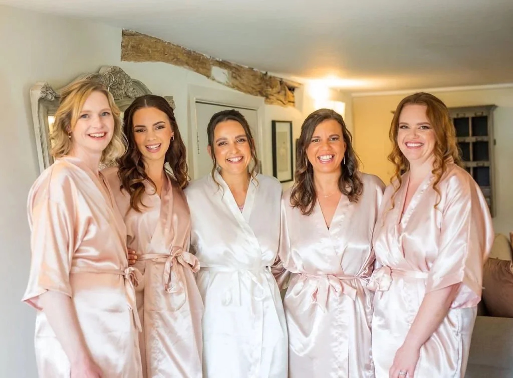 Bride and bridesmaids in robes after hair and makeup